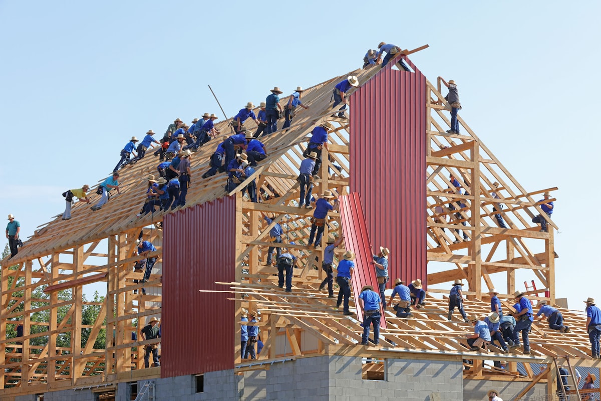 A crew framing a timber structure on a job site